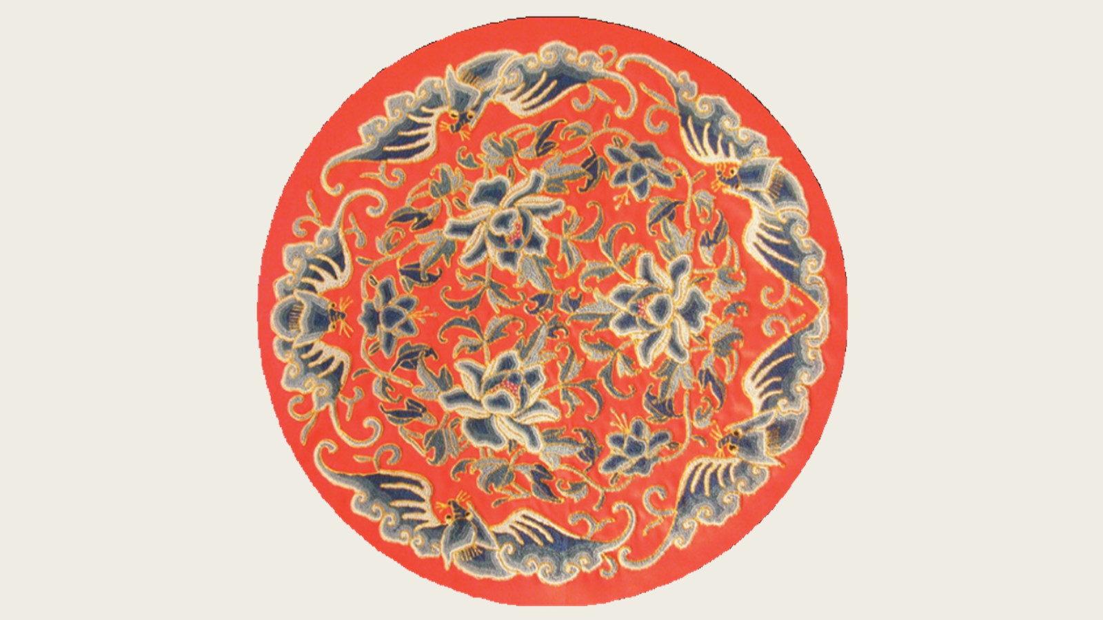 Round red embroidery with five bats surrounding interwoven lotus flowers worked in graded blue threads.