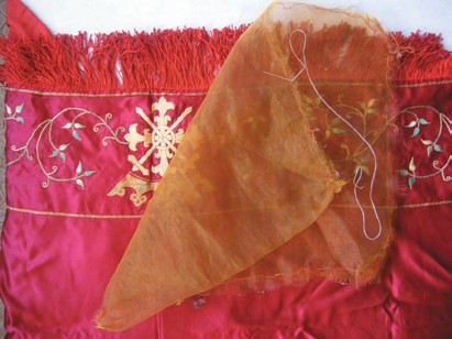A gauze cover placed over embroidery during gentle washing