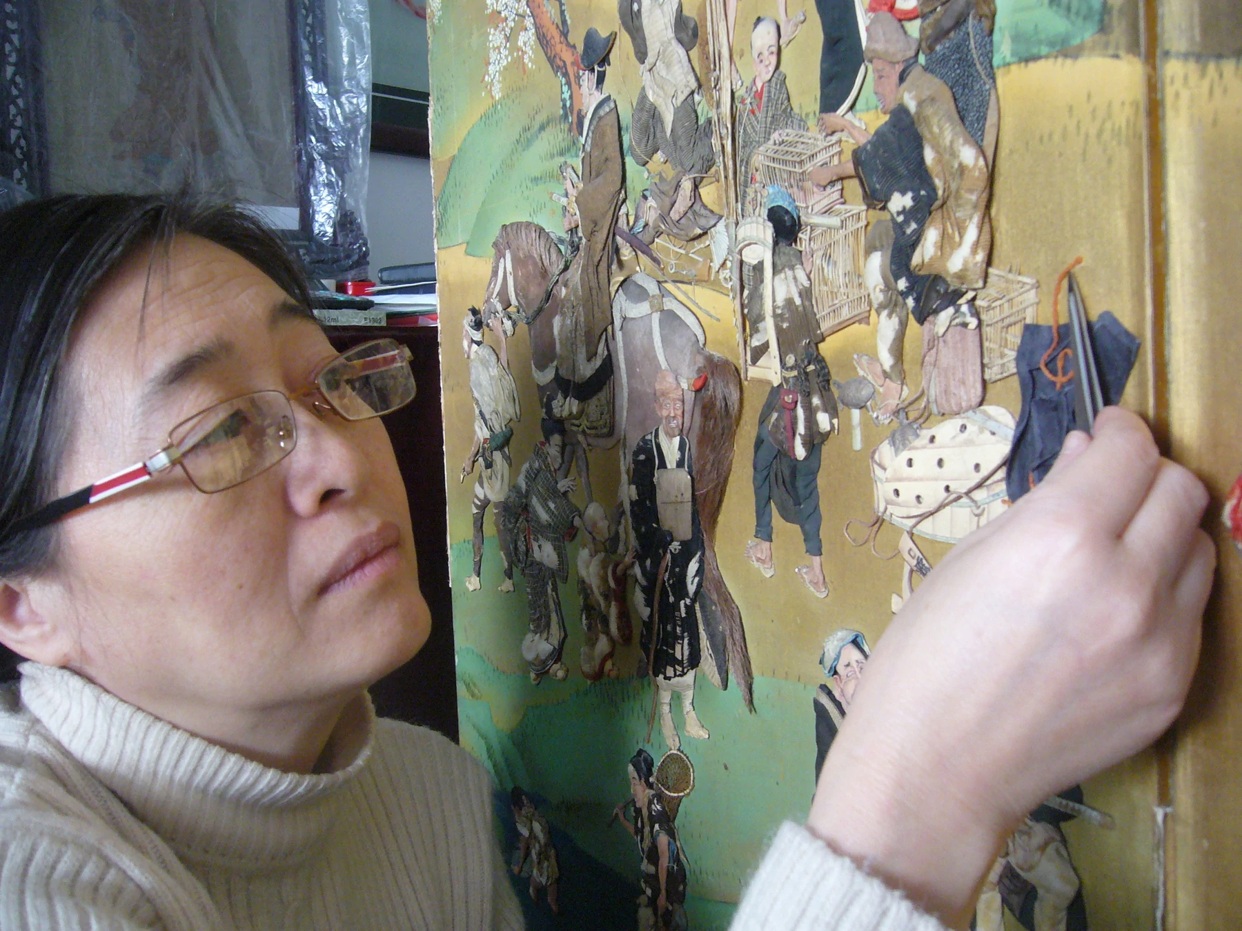 Detail of conservation work on the Japanese raised-embroidery screen