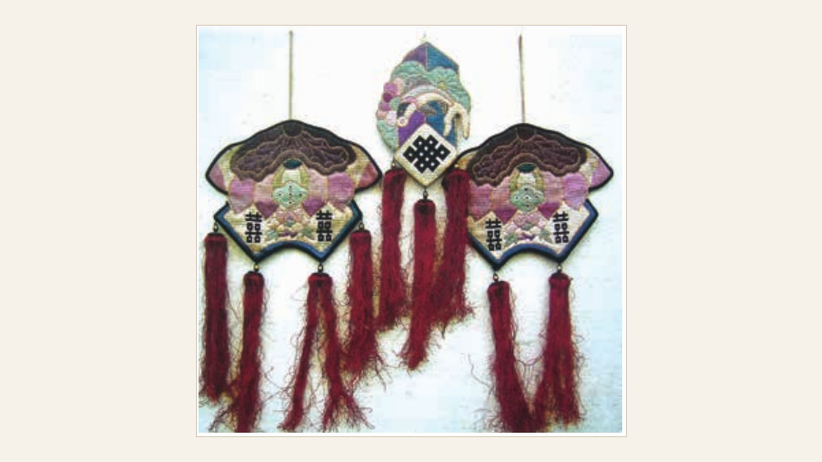 A Qing-dynasty Xiang embroidered mosquito-net valance with fan-shaped panels and tassels