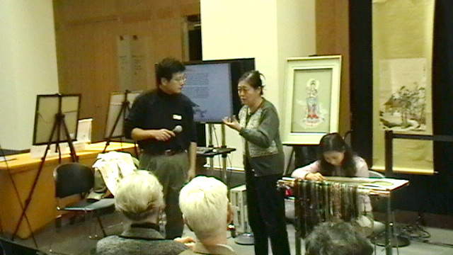 A Chinese embroidery presentation beside displayed works and threads, from the Institute’s 2008 San Francisco archive.