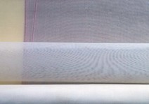 Pale fabric samples with visible grid-like patterns