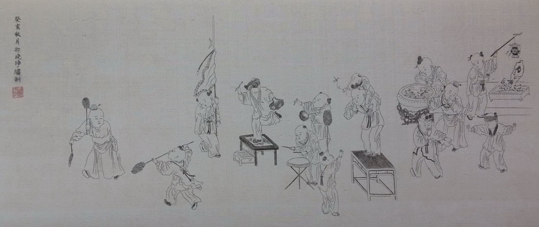Wide hair-embroidery scene of children at play, worked in fine dark and grey lines on a pale ground.